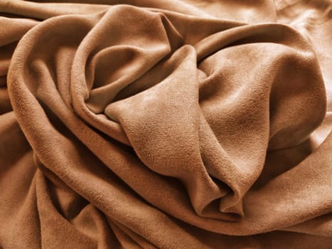 Fabric for curtains and curtains. Beautiful brown - terracotta color. Soft velvet with velvet. The curtain material is carelessly folded on a horizontal surface. Fabric sample. Interior Design Option.