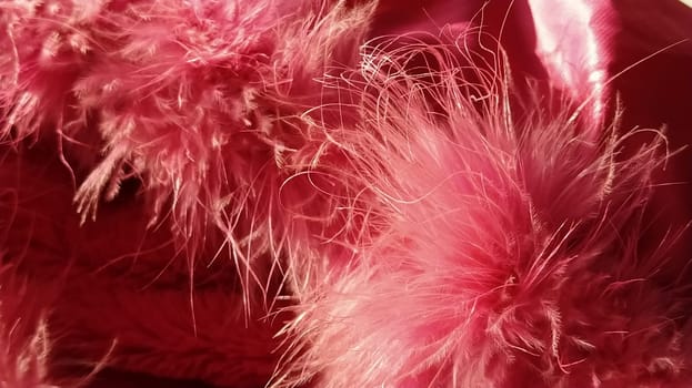 Pink faux fur or pink colored natural bird feathers close-up. Light feathers boa. Delicate texture. Greeting card Happy Valentines Day. Collar from a women's or girl's jacket. Bright pink or color.