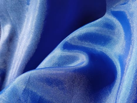Blue silk lining. Close-up. A piece of fabric on curtains or a raincoat.