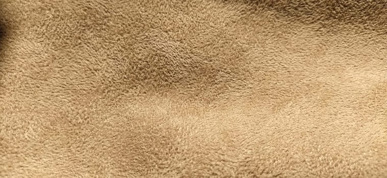 beige suede fabric. Close-up of a faux suede or nubuck fabric. Sewing accessories and fabrics. Short pile texture.
