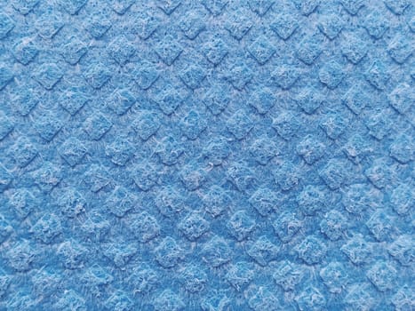 blue sponge for washing dishes, close-up. Abstract blue background.
