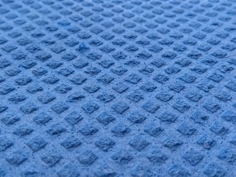 Dishwashing sponge background. close-up of blue dishwashing sponge. Soft focus.