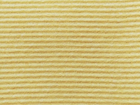 Close-up of a striped fabric with raised printing. Horizontal stripes on yellow microfiber or sponge.