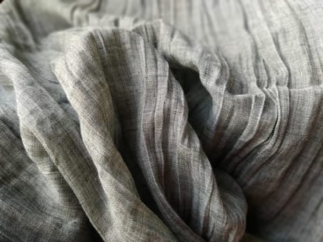 Fabric sheer curtain fabric. Beautiful gray color. The curtain material is carelessly folded and wrinkled. Fabric sample. Interior design option.