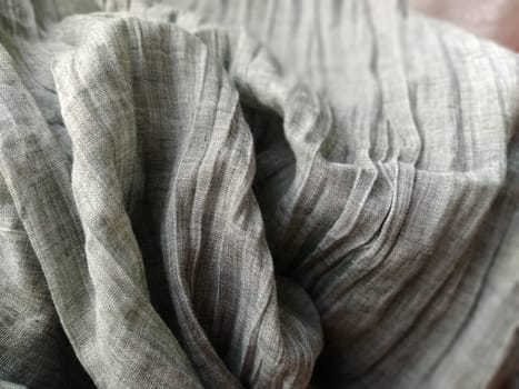 Fabric sheer curtain fabric. Beautiful gray color. The curtain material is carelessly folded and wrinkled. Fabric sample. Interior design option.