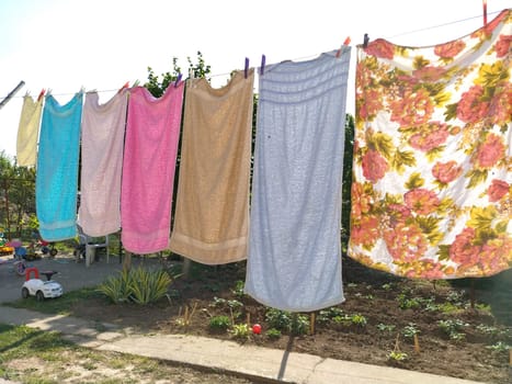 Sremska Mitrovica, Serbia July 10, 2020, towels and clothes dry on a rope. Housewife worries. The wet cloth is hung on clothespins for further drying. big washing.