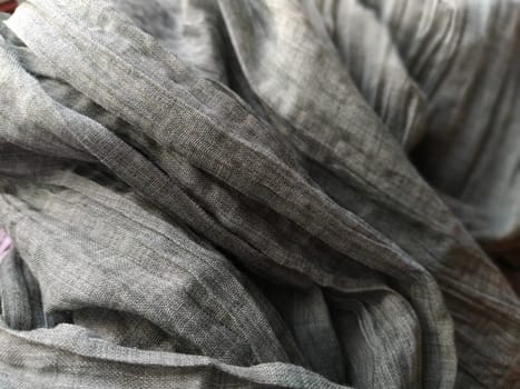 Fabric sheer curtain fabric. Beautiful gray color. The curtain material is carelessly folded and wrinkled. Fabric sample. Interior design option.