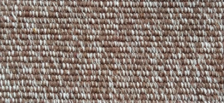 close up of fabric texture for background. Woven coarse cotton fabric with white, beige and brown threads. Banner