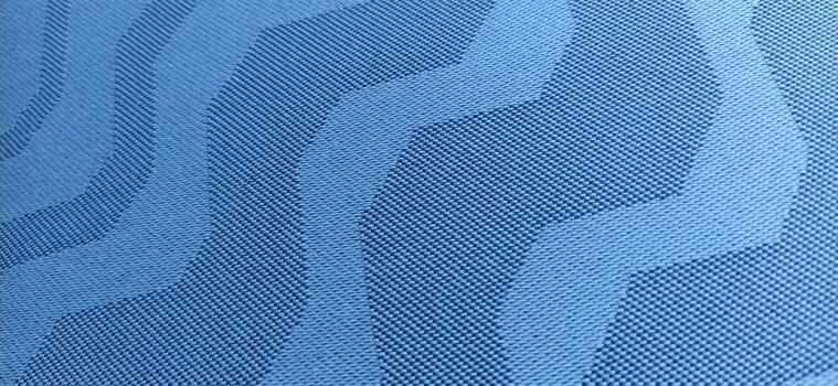 abstract blue curves on a gray background. Fabric texture. Wide lines and winding stripes.