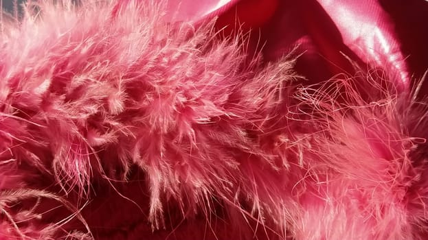Pink faux fur or pink colored natural bird feathers close-up. Light feathers boa. Delicate texture. Greeting card Happy Valentines Day. Collar from a women's or girl's jacket. Bright pink or color.