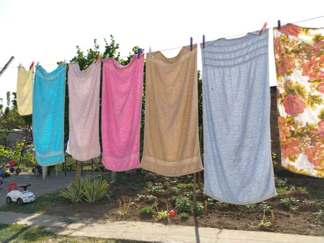 Sremska Mitrovica, Serbia July 10, 2020, towels and clothes dry on a rope. Housewife worries. The wet cloth is hung on clothespins for further drying. big washing.
