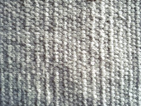 beautiful knitwear in white color. Horizontal rows of front and back loops knitted manually by knitting needles. Soft fluffy warm wool yarn. Close-up.