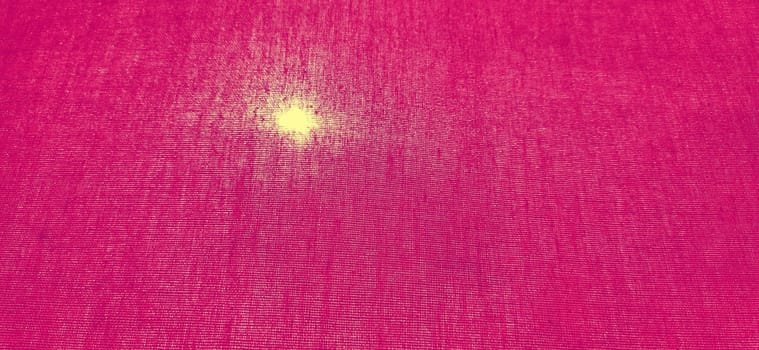 Sun or a lamp through bright pink thick curtains. Bright background of fuchsia flowers with a glowing circle. Back light on the left.