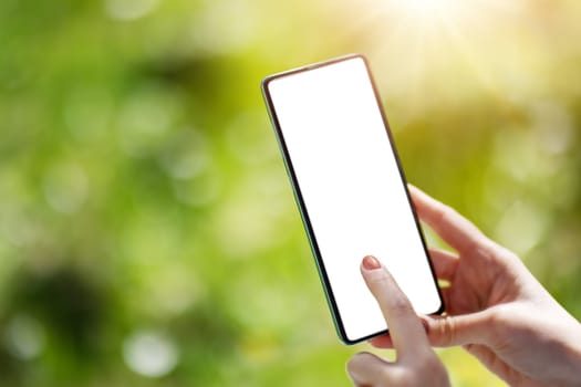 Closeup view of the woman's hands holding smartphone. Concept of the background, wallpaper and backdrop.