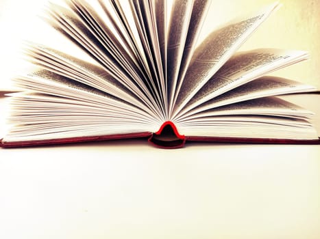 the opened book on the white table.