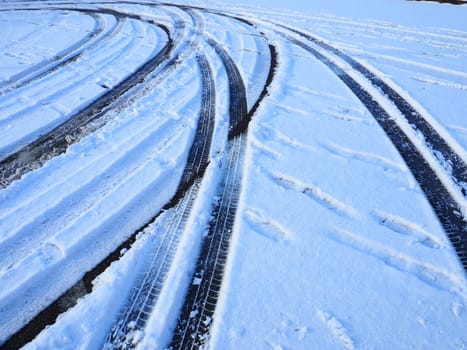 Snowdrifts on the side of the road. Bad weather and traffic. Snow on asphalt. Difficult driving conditions. Winter slosh on the road. Braking distance of a car
