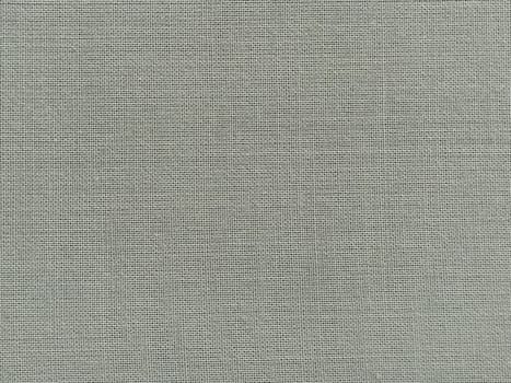 pale light green fabric. A piece of woolen fabric laid out neatly on the surface. Interlacing and textile texture. dress fabric or for kitchen needs, tablecloth or curtains, Close-up.