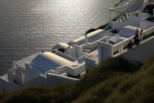 Whitewashed houses with terraces and pools and a beautiful view in Imerovigli on Santorini island, Greece