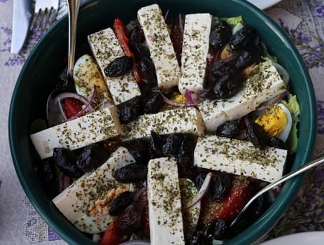 Greek salad with feta cheese and black olives. Typical delicious greek style lunch