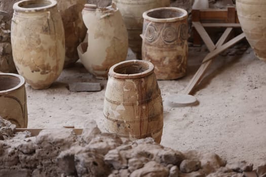 Santorini, Greece - July 01, 2021: Recovered ancient pottery in prehistoric town of Akrotiri, excavation site of a Minoan Bronze Age settlement on the Greek island of Santorini