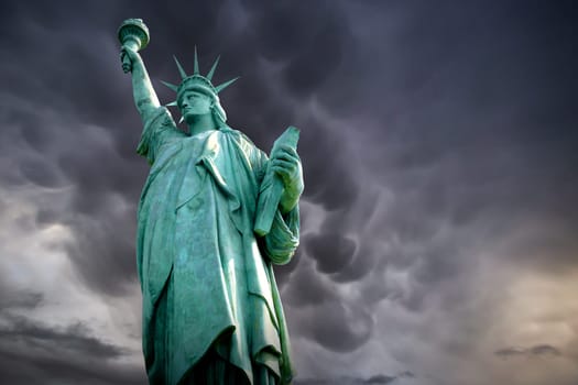Statue of Liberty standing in a stormy background