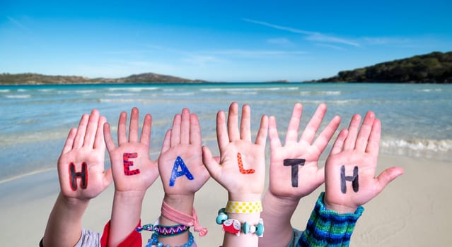 Children Hands Building Colorful English Word Health. Summer Ocean, Sea And Beach As Background.