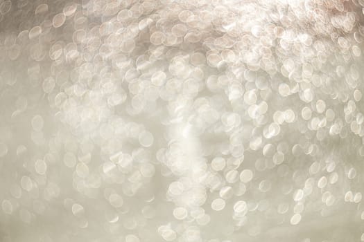 Creative background image. Light transparent drops of water in blur. Blurred bokeh on light background.