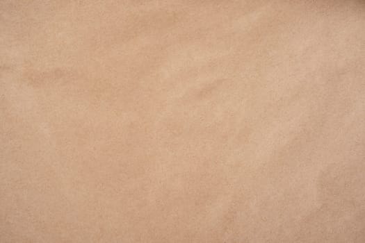 Background image of rough crumpled recycled textured kraft paper. Top view. Copy space