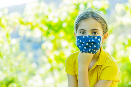 Little girl with mask against corona virus covid outdoor