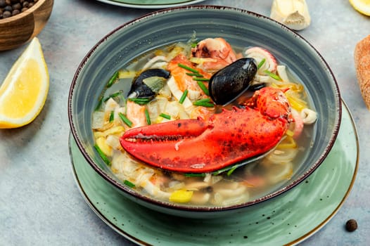 Fresh soup with lobster, mussels, shellfish and fish. Seafood soup. Copy space