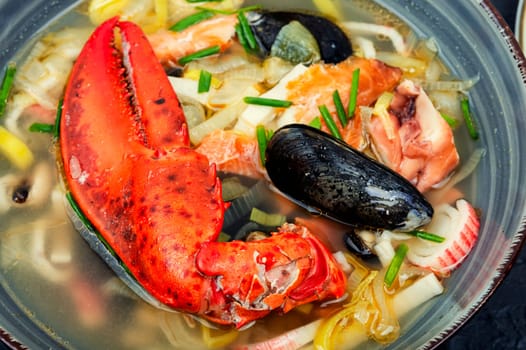 Fresh soup with lobster, mussels, shellfish and fish. Seafood soup. Copy space