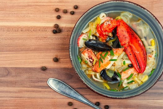 Fresh soup with lobster, mussels, shellfish and fish. Seafood soup. Copy space