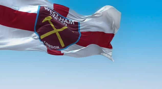 London, UK, Oct. 2022: West Ham United F.C. flag waving in the wind on a clear day. West Ham United F.C is an English football club based in London. Illustrative editorial 3d illustration render