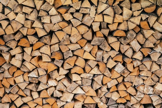 Texture background image of chopped firewood stacked in a woodpile. Copy space