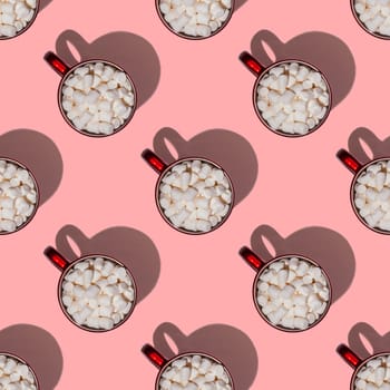 Seamless endless pattern of red cups with hot chocolate, coffee or cocoa with marshmallows with hard shadows isolated on light pink background. Top view