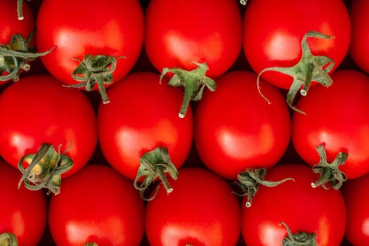 Background image of lying rows of red ripe cherry tomatoes. Top view. Flat lay. Copy space