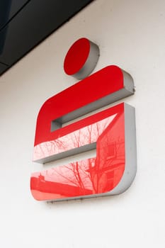 Illuminated sign with the symbol of the Sparkasse, Savings Bank on a facade in Bad Harzburg in Germany