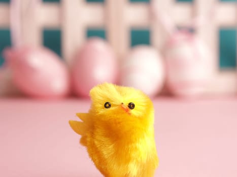 Close up of cute chick with Easter eggs background