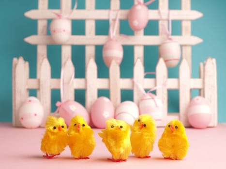 Close up of five cute chicks with Easter eggs background