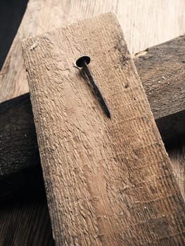 Wooden cross with an old rusty nail symbolizes the crucifixion of Jesus. Easter concept with text free space