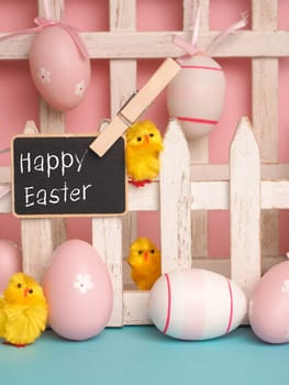 Close up of a cute chick with the words Happy Easter and an Easter egg background