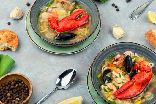 Tasty soup with lobster, mussels, shrimps and fish. Seafood soup. Copy space