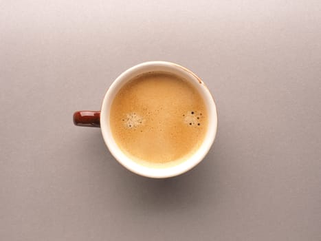 Brown espresso cup with a delicious smelling organic espresso, view from above, tasty food, daily beverage