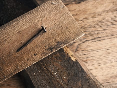 Wooden cross with an old rusty nail symbolizes the crucifixion of Jesus. Easter concept with text free space
