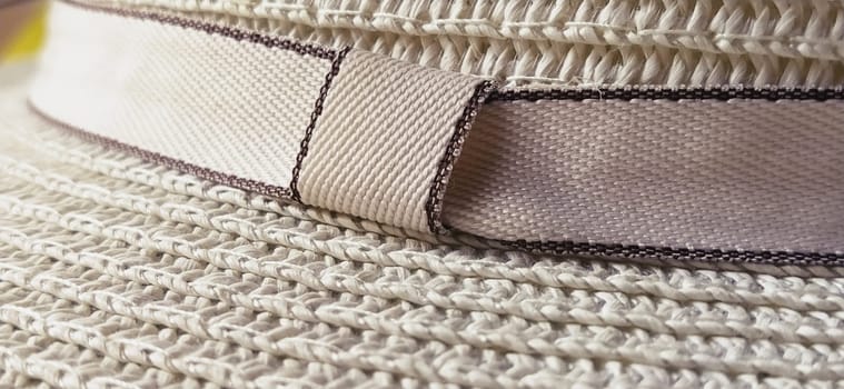 Hatband. A strap or adornment on the headdress. Straw hat close-up. Travel and leisure theme. Summer holiday.