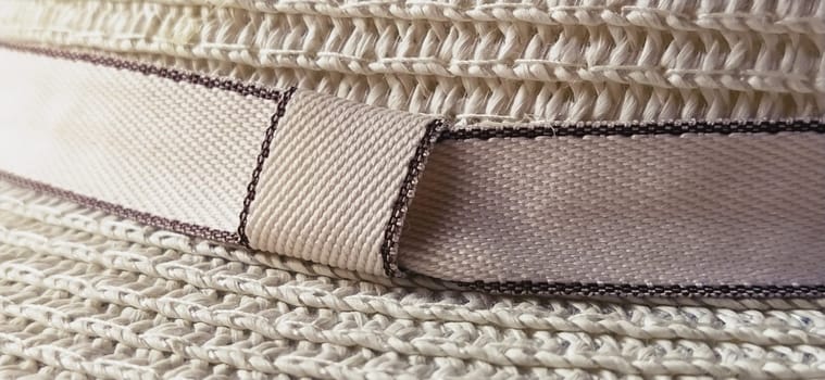 Hatband. A strap or adornment on the headdress. Straw hat close-up. Travel and leisure theme. Summer holiday.