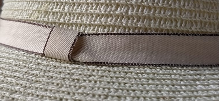Hatband. A strap or adornment on the headdress. Straw hat close-up. Travel and leisure theme. Summer holiday.