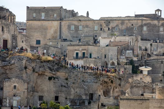 Matera, Italy - September 15, 2019: Tourists in the Sassi di Matera a historic district in the city of Matera. Basilicata. Italy