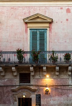 Matera, Italy - September 14, 2019: Facade of the house with shutters and balcony in Matera. Basilicata, Italy