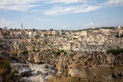 Panoramic view of Sassi di Matera a historic district in the city of Matera, well-known for their ancient cave dwellings from the Belvedere di Murgia Timone,  Basilicata, Italy